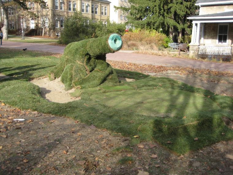 Photo of cannon covered in sod by turf students