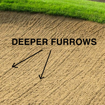 A golf course bunker with deep furrows