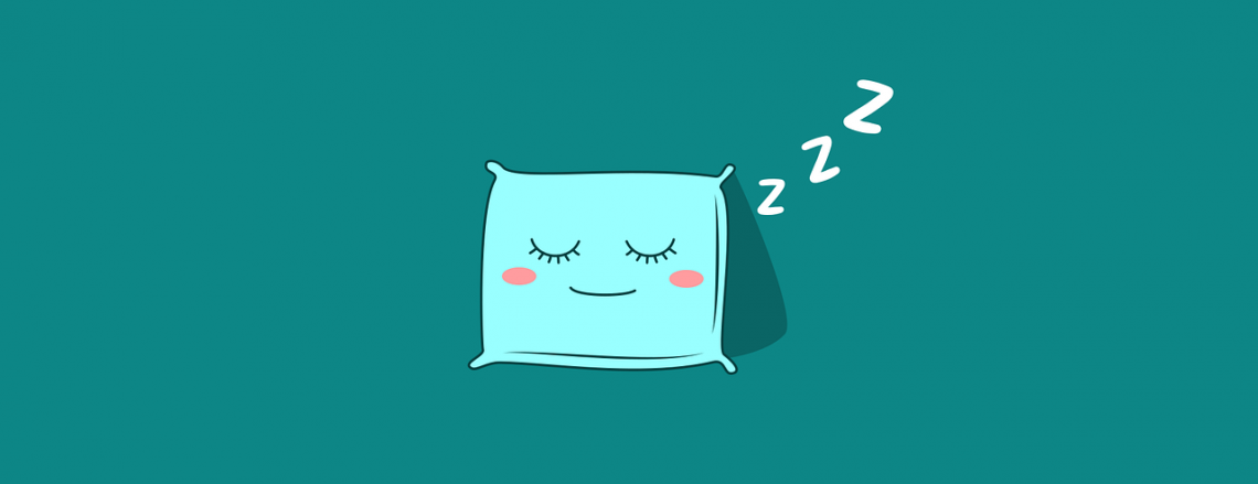A pillow with a smiling face, the eyes are closed and it seems to be sleeping