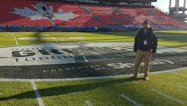 Robert Heggie standing on the BMO Field, Freshly Painted for the Grey Cup