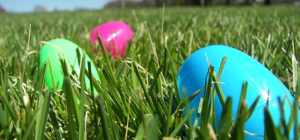 Three plastic eggs laying on grass